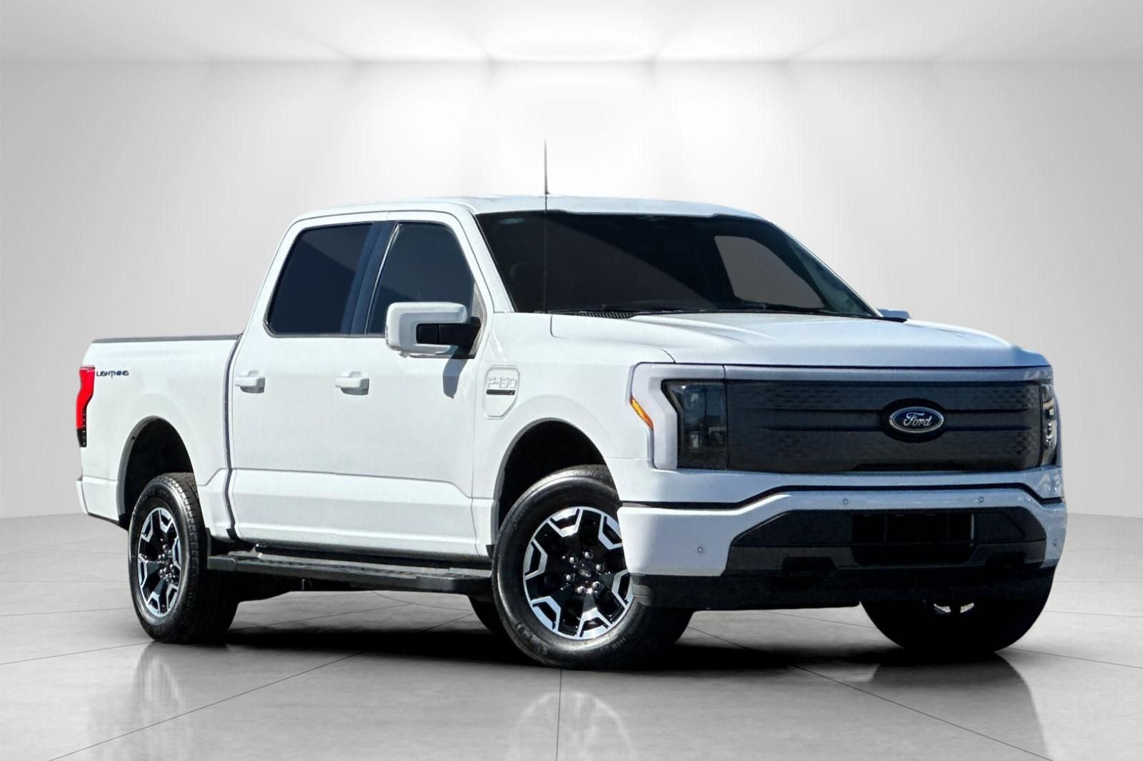 2023 Ford F-150 Lightning XLT in Oxford White — front three-quarter view